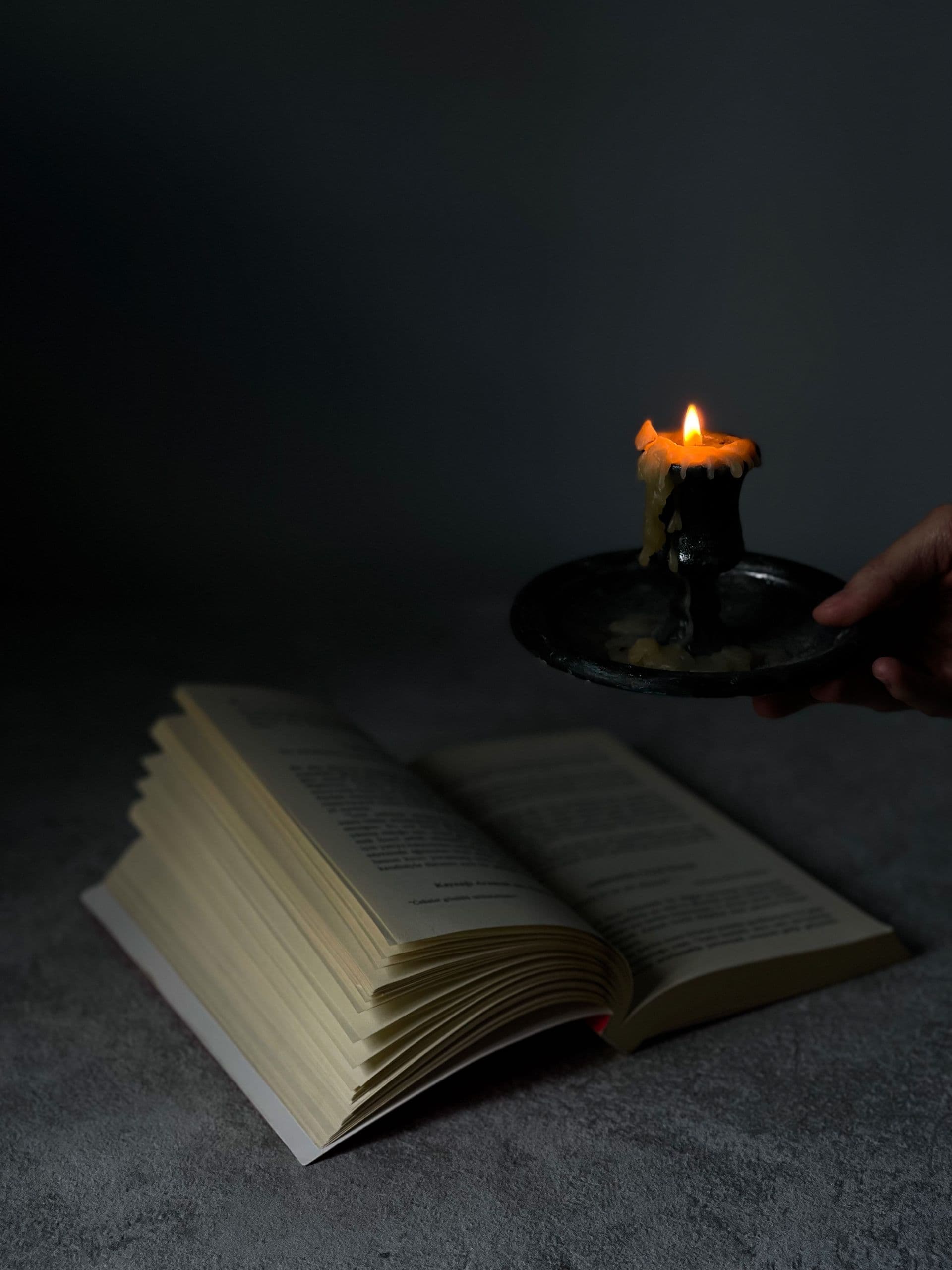 A candlelit open book representing Runebook story play